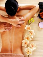Adult woman in spa salon having body massage. Adult woman in spa salon having body relaxing massage.